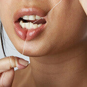 woman flossing her teeth