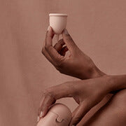 woman holding menstrual cup & case