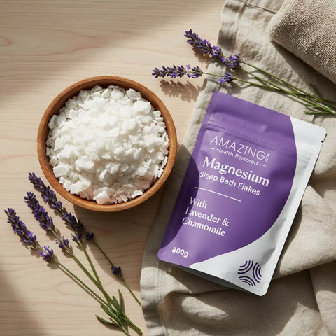 Amazing You Magnesium Sleep Bath Flakes lifestyle shot of the purple pouch beside a bowl of white flakes and sprigs of lavender