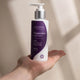 Amazing You Magnesium Sleep Lotion 125ml lifestyle shot of an open palm holding the pump bottle against a pale backdrop, styled lifestyle photo