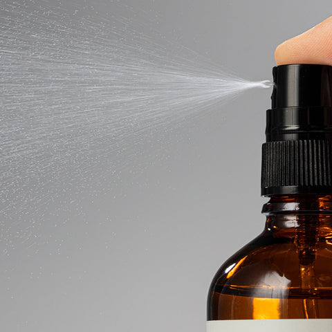 Close up of the ultra-hydrating mist being sprayed into the air.