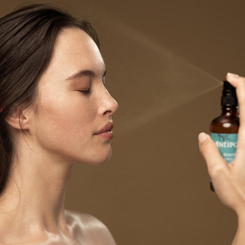 Model spraying ultra-hydrating mist on her face.