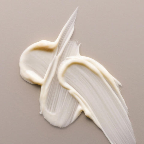 Swatches of antipodes avocado pear night cream on a beige background.