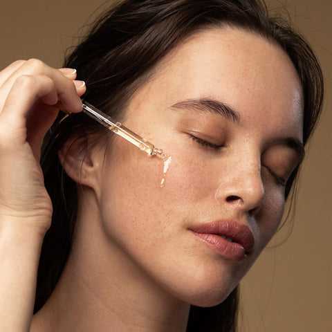 Model applying eve bio retinol line reduction serum to her cheek.