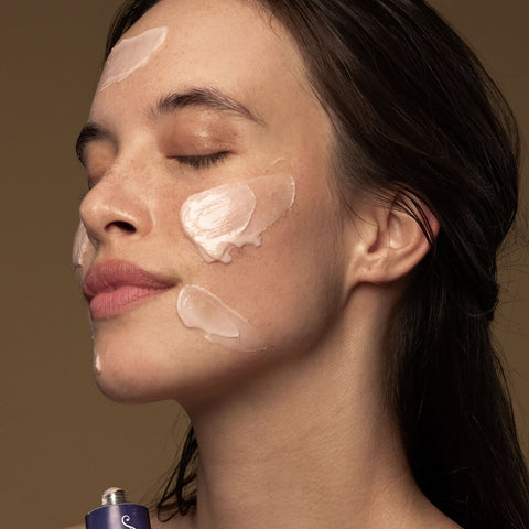 Model wearing flora probiotic skin rescue mask on her face.