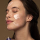 Model wearing flora probiotic skin rescue mask on her face.