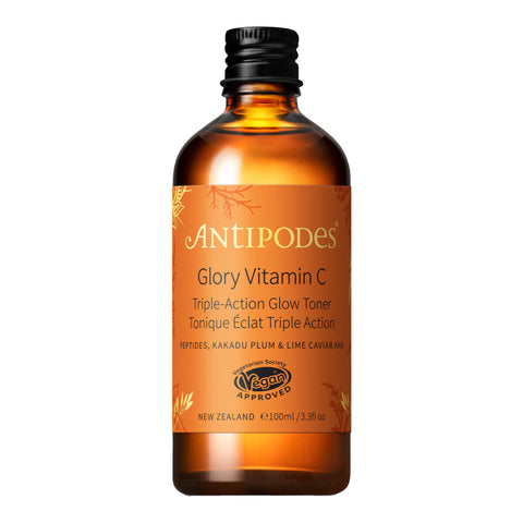A bottle of Glory Vitamin C Triple-Action Glow Toner by Antipodes, with a brown tinted glass container and a black cap.