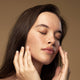 Model massaging glory toner into her face.