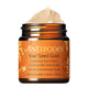 A jar of Antipodes Kiwi Seed Gold Luminous Eye Cream with the lid open, showing the cream inside. The label indicates that it contains 24K gold and kakadu plum.
