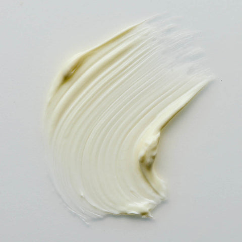 Swatch of lime caviar collagen rich firming cream, with a smooth and thick texture on a grey background.