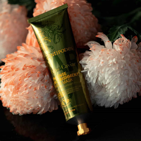 Antipodes Caviar Intense Replenishment Mask tube on decorative flowers.