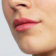 Dusky sound pink lipstick swatch on a person's lips.