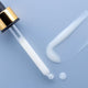 Dropper applicator with a swatch of maya serum on a baby blue background.