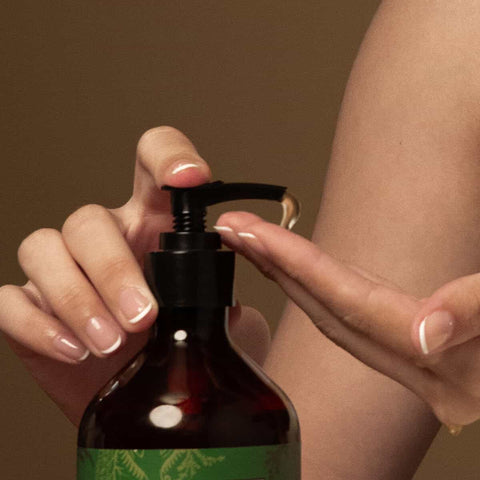Person pumping a small amount of nirvana hand wash onto her hand.