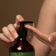 Person pumping a small amount of nirvana hand wash onto her hand.
