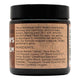 Jar of balm with label detailing ingredients and benefits on a white background.