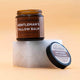 Jar of 'Gentleman's Tallow Balm' by barefoot skincare on a beige background on top of a chunk of marble.