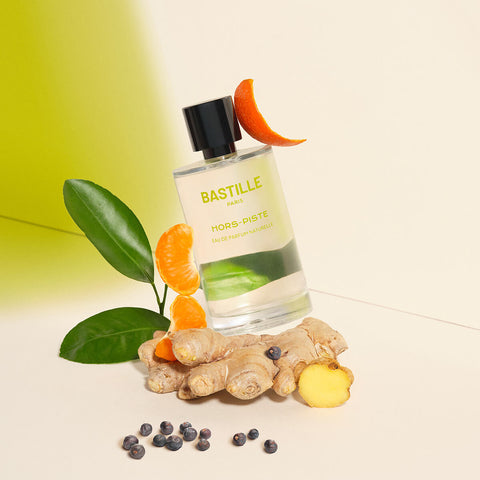 100ml bottle Bastille Hors-Piste Perfume, natural vegan perfume styled with ginger and mandarin slices.