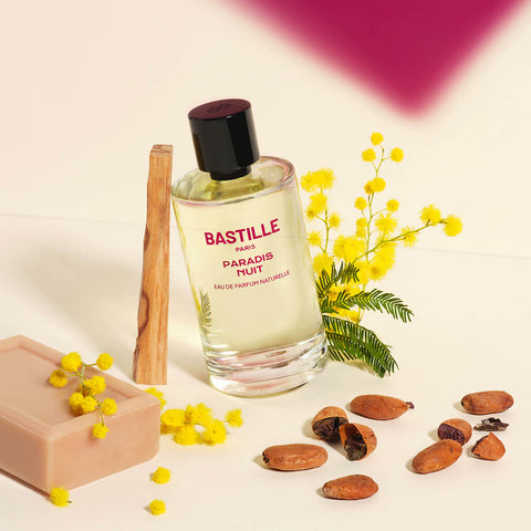 100ml bottle Bastille Paradis Nuit Perfume, natural vegan perfume styled with sandalwood, flowers, and cocoa beans.