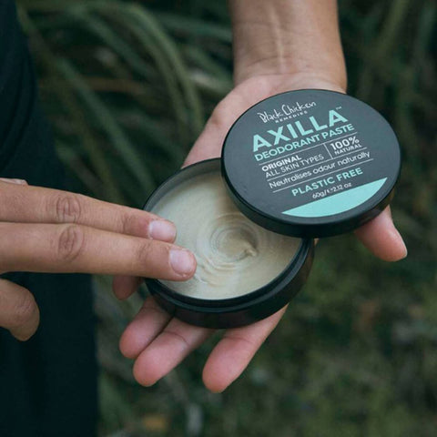 Black Chicken Remedies Axilla Deodorant Paste Original Plastic Free 60g lifestyle close up of two hands holding the open tin to show the paste