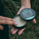 Black Chicken Remedies Axilla Deodorant Paste Original Plastic Free 60g lifestyle close up of two hands holding the open tin to show the paste