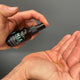 Black Chicken Remedies H.I.S Face & Beard Oil 30ml lifestyle shot of a hand pumping the oil from the dark bottle onto an open palm