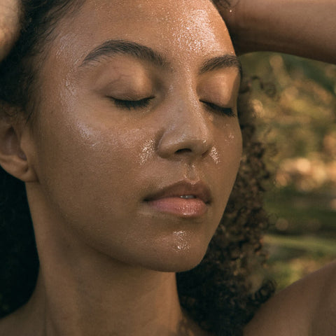 Model using Black Chicken Remedies Natural Retinol Night Mask on face, smooths wrinkles, boosts collagen, and hydrates overnight.