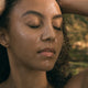 Model using Black Chicken Remedies Natural Retinol Night Mask on face, smooths wrinkles, boosts collagen, and hydrates overnight.