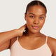 Boody Base Layer Cami Top Nude lifestyle close up of a smiling woman with her hand at her neck wearing the nude cami, styled lifestyle photo