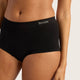 A close-up of a model wearing black high-waisted briefs with the brand name 'BOODY' printed in white on the front waistband, set against a light gray studio background.