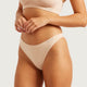 Boody G-String Shell lifestyle close up of a person's torso wearing the nude g-string and a nude top, styled lifestyle photo, single image