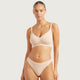 Boody G-String Shell lifestyle shot of a woman with her hair up in a nude bra and the nude g-string, front view, styled lifestyle photo