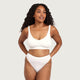 Boody G-String White lifestyle shot of a woman with long curly hair in a white bra and the white g-string, styled lifestyle photo