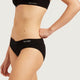 Boody Period & Leak Proof Classic Bikini Moderate-Heavy in black, close-up of the front waistband and bikini on a model's torso and hip