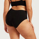 Boody Period & Leak Proof Full Briefs Light-Moderate lifestyle back view of a person wearing the black full briefs, turned slightly to the side
