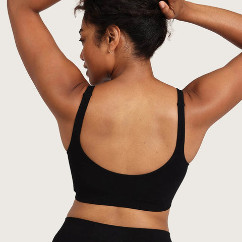 Boody Seamfree Crop Bra Black lifestyle back view of a woman with her hair up and arms raised in the black bra, styled lifestyle photo