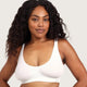 Boody Seamfree Crop Bra White lifestyle shot of a woman with long curly hair in the white bra, hands on her hips, styled lifestyle photo