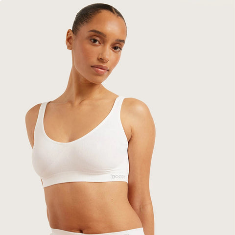 Boody Seamfree Crop Bra White lifestyle shot of a woman with her hair up in the white bra, front view, styled lifestyle photo