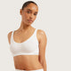 Boody Seamfree Crop Bra White lifestyle shot of a woman with her hair up in the white bra, front view, styled lifestyle photo