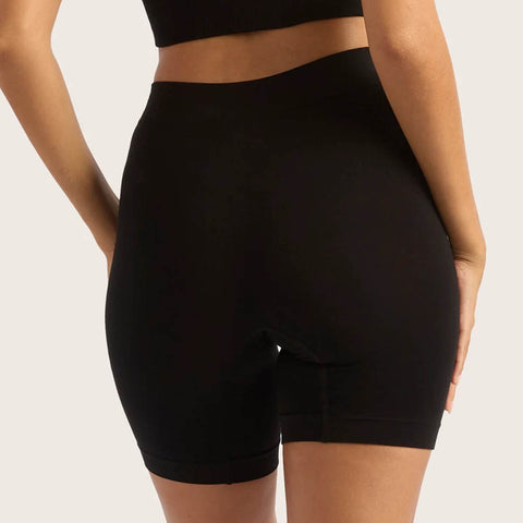 Boody Seamfree Undershorts 6 inch Black lifestyle back view of a person wearing the black shorts, styled lifestyle photo, single image