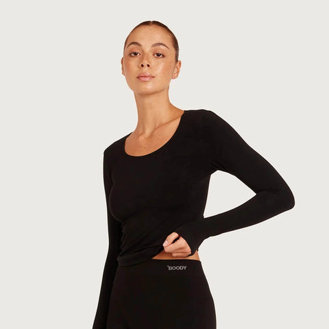 Boody Womens Base Layer Long SLeeve Top in black modelled by a young woman.