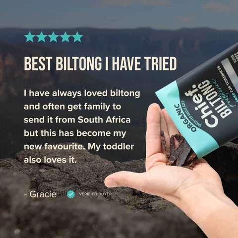 Chief Biltong packaging with a hand holding biltong strips against a mountainous background with a 5 star review quoted.