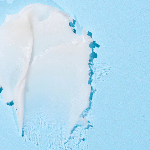 Dr Zoo Nose & Paw Butter swatch showing thick white texture on a light blue background.