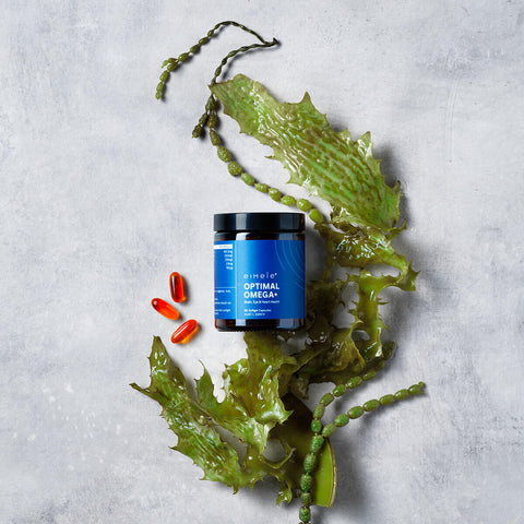 eimele Optimal Omega+ jar styled with capsules and algae.