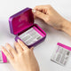 Hands opening eimele Sleep Glow tin, sleep support formula with phytonutrient and antioxidant benefits.