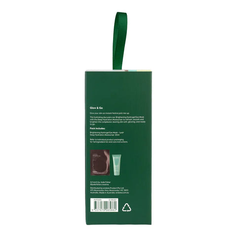 The back of a dark green skincare gift set box with a matching green loop handle, showing product details, a barcode, and a small photo of the included items on a white background.