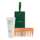 Endota hair care set featuring a white tube of signature blend hair mask, a dark green presentation box with a handle, and a wooden wide-tooth comb with multicolored teeth, on a white background.