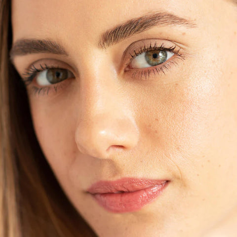 Ere Perez Almond Brow Pencil Perfect 1.1g lifestyle close up portrait of a woman with light eyes and neatly defined eyebrows, face only