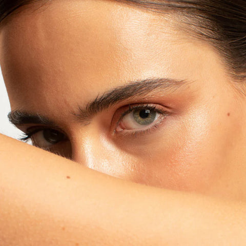 Ere Perez Aloe Gel Lash & Brow Mascara Clear 10ml lifestyle close up of a woman with light eyes and her forearm across her face