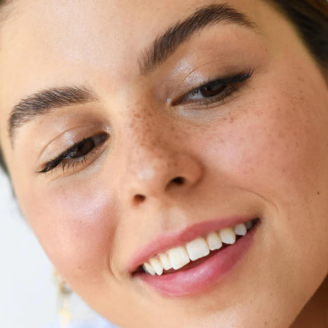Ere Perez Argan Brow Hero Perfect 3.5ml lifestyle close up portrait of a smiling woman with defined brows, styled lifestyle photo
